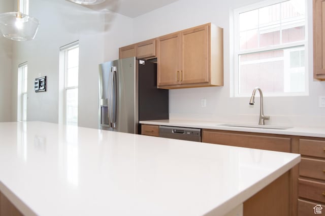11511 S Pebble Pond Rd, South Jordan, UT 84009 - kitchen featuring appliances with stainless steel finishes, light countertops, decorative light fixtures, and brown cabinets