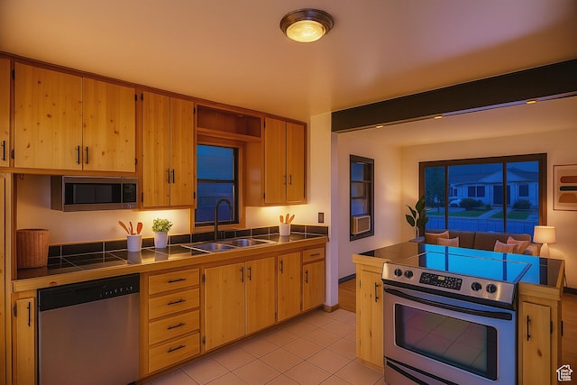 8646 W Florence Dr, Magna, UT 84044 - kitchen featuring stainless steel appliances, tile counters, and light tile patterned floors