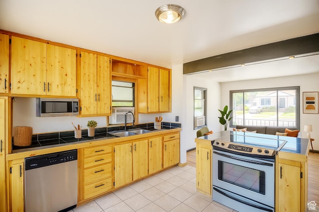8646 W Florence Dr, Magna, UT 84044 - kitchen featuring stainless steel appliances, tile counters, light brown cabinets, and light tile patterned floors