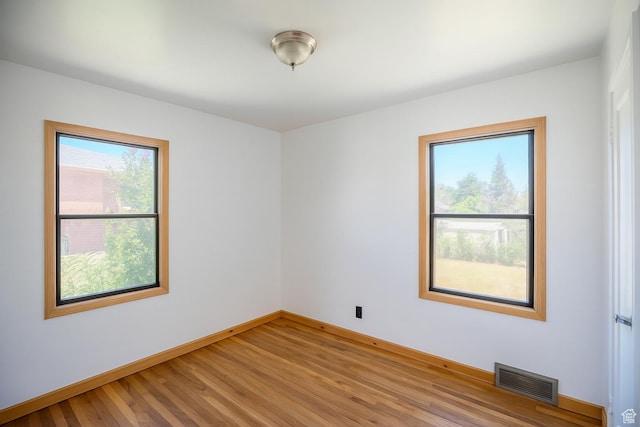 8646 W Florence Dr, Magna, UT 84044 - unfurnished room with baseboards and light wood-type flooring