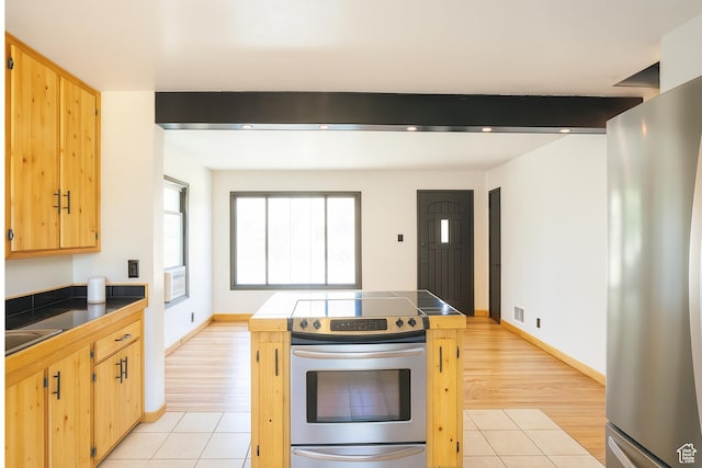 8646 W Florence Dr, Magna, UT 84044 - kitchen with stainless steel appliances, light brown cabinets, tile counters, and light tile patterned floors