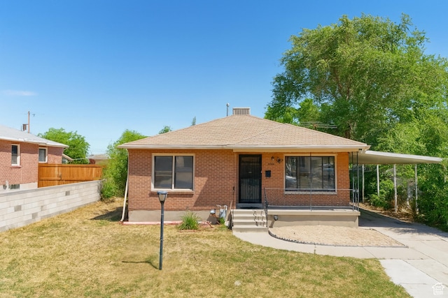 8646 W Florence Dr, Magna, UT 84044 - view of front of house featuring concrete driveway, a carport, brick siding, and a shingled roof