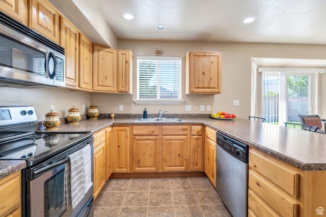 52 N 1100 W, Springville, UT 84663 - kitchen featuring stainless steel appliances, a peninsula, light brown cabinetry, healthy amount of natural light, and recessed lighting