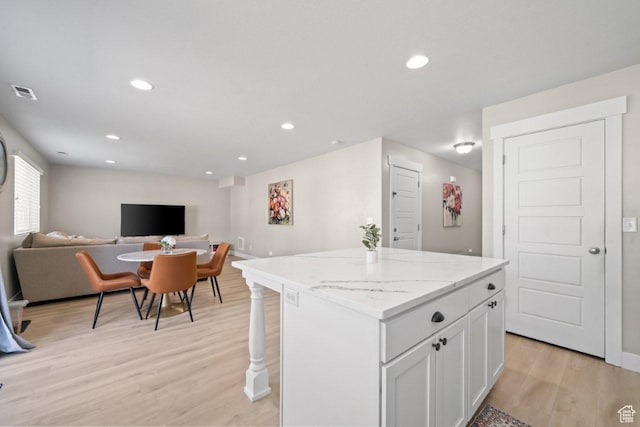3634 S Creek Side Ln, Syracuse, UT 84075 - kitchen with open floor plan, a kitchen island, light wood-type flooring, white cabinetry, and recessed lighting