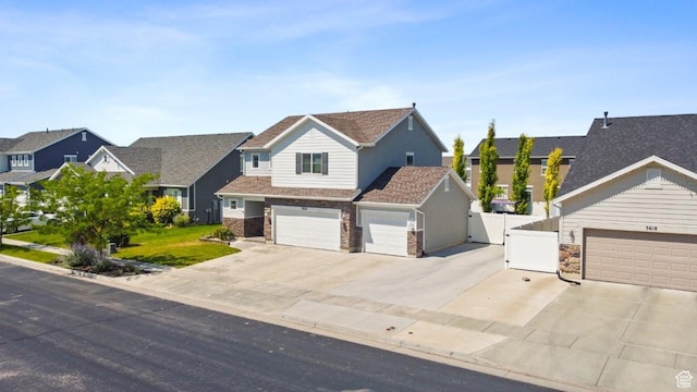 3634 S Creek Side Ln, Syracuse, UT 84075 - view of front of house with a gate, concrete driveway, a garage, and a residential view