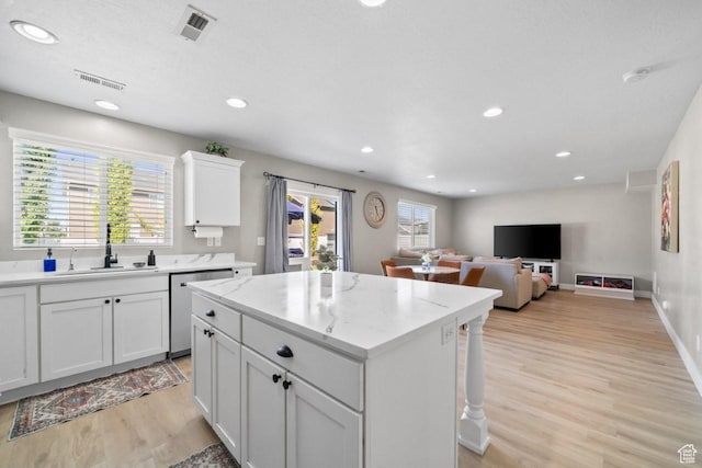 3634 S Creek Side Ln, Syracuse, UT 84075 - kitchen with stainless steel dishwasher, light wood-style floors, a kitchen island, recessed lighting, and white cabinetry