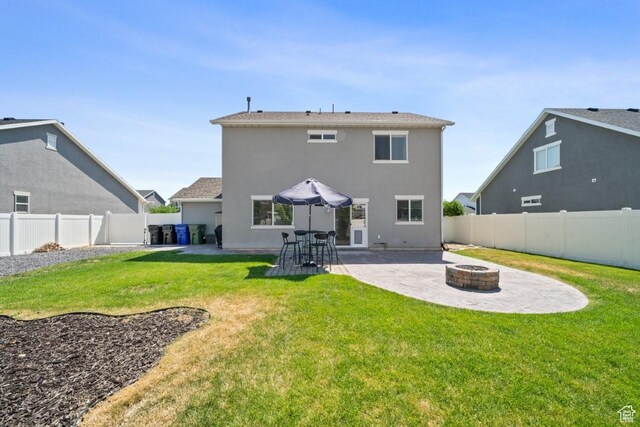 3634 S Creek Side Ln, Syracuse, UT 84075 - back of property featuring a fire pit, a patio, a fenced backyard, and stucco siding