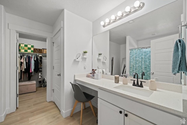 3634 S Creek Side Ln, Syracuse, UT 84075 - bathroom featuring wood finished floors, vanity, a spacious closet, and a shower with shower curtain