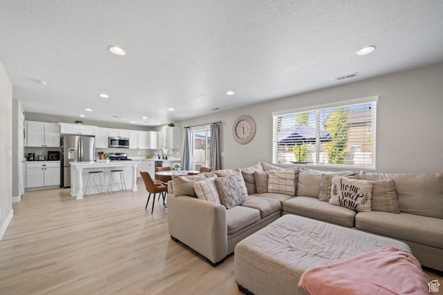 3634 S Creek Side Ln, Syracuse, UT 84075 - living room with light wood-style flooring and recessed lighting