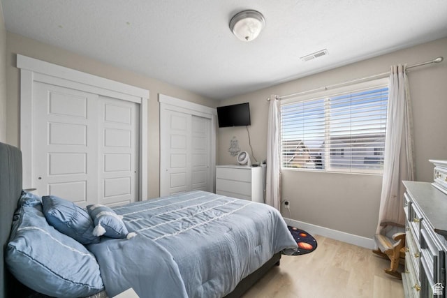 3634 S Creek Side Ln, Syracuse, UT 84075 - bedroom featuring light wood-style flooring and two closets