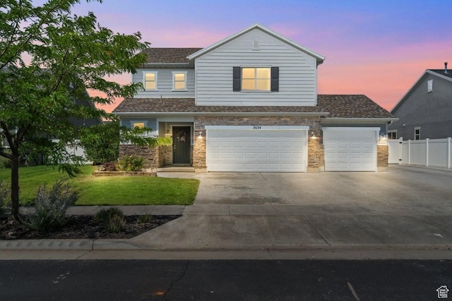 3634 S Creek Side Ln, Syracuse, UT 84075 - view of front facade with concrete driveway, stone siding, a shingled roof, an attached garage, and a garage