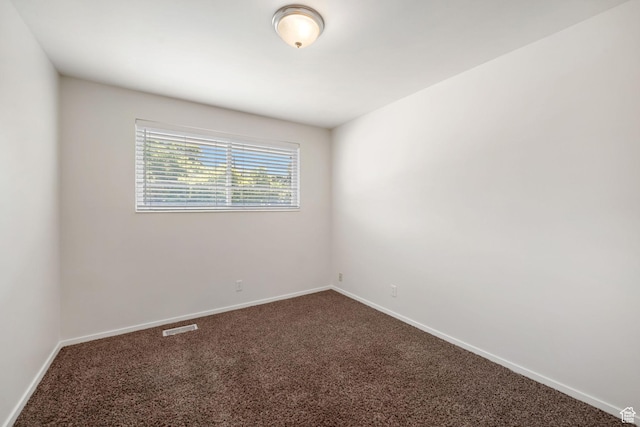 5726 S Highland Dr E, Holladay, UT 84121 - spare room with dark colored carpet and baseboards