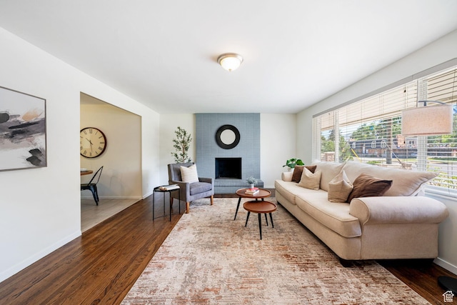 5726 S Highland Dr E, Holladay, UT 84121 - living room featuring healthy amount of natural light, dark wood-style floors, and a brick fireplace