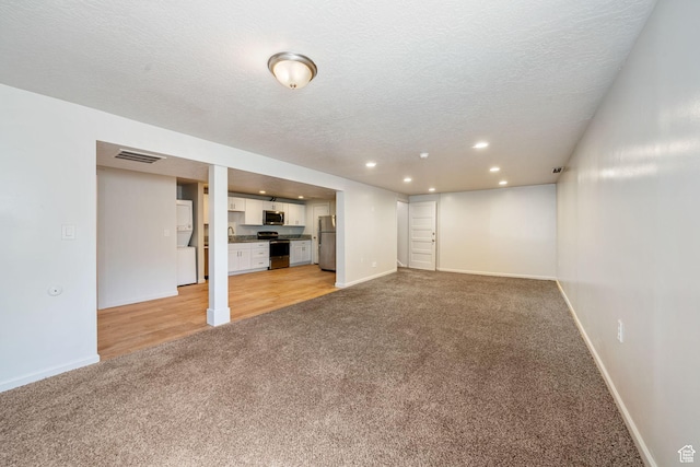 5726 S Highland Dr E, Holladay, UT 84121 - unfurnished living room with light colored carpet, recessed lighting, and a textured ceiling