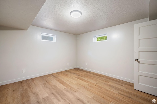 5726 S Highland Dr E, Holladay, UT 84121 - below grade area with light wood-style floors and a textured ceiling