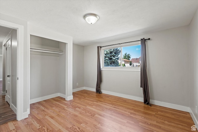 224 E 1950 S, Clearfield, UT 84015 - unfurnished bedroom featuring light wood-type flooring, a closet, and a textured ceiling