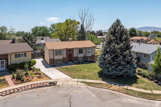 224 E 1950 S, Clearfield, UT 84015 - bi-level home featuring a residential view, brick siding, a gate, concrete driveway, and a mountain view