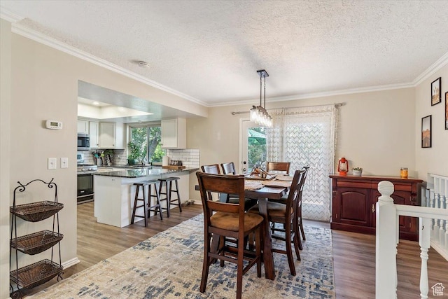2772 E 3575 N, Layton, UT 84040 - dining space with wood finished floors, healthy amount of natural light, crown molding, and a textured ceiling