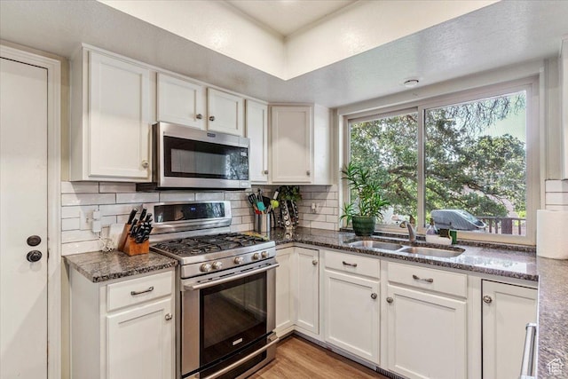 2772 E 3575 N, Layton, UT 84040 - kitchen featuring stainless steel appliances, white cabinetry, decorative backsplash, and plenty of natural light