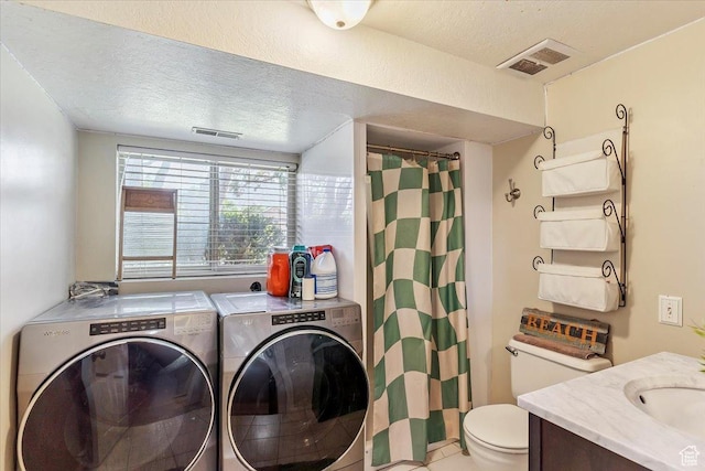 2772 E 3575 N, Layton, UT 84040 - laundry room featuring separate washer and dryer, a textured ceiling, and tile patterned floors