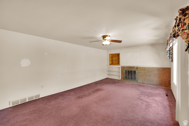 640 E 300 N, Pleasant Grove, UT 84062 - unfurnished living room featuring a brick fireplace, dark carpet, ceiling fan, and built in shelves