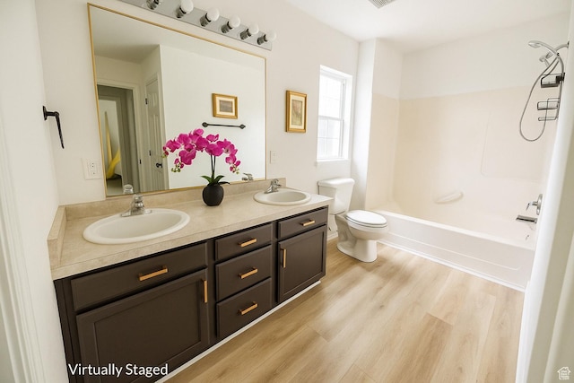4518 Silver Spur Way, Eagle Mountain, UT 84005 - full bath featuring double vanity, wood finished floors, and shower / washtub combination