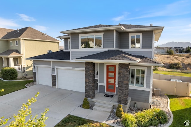 7672 N Evans Ranch Dr E, Eagle Mountain, UT 84005 - prairie-style house featuring driveway, a mountain view, an attached garage, and stone siding