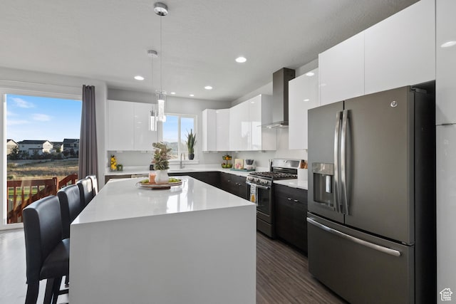 7672 N Evans Ranch Dr E, Eagle Mountain, UT 84005 - kitchen with stainless steel fridge, gas range, wall chimney range hood, modern cabinets, and white cabinetry