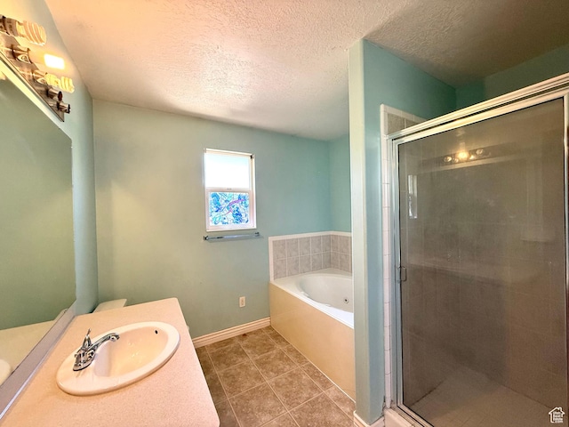 2573 W Remuda Dr, Farr West, UT 84404 - full bath featuring vanity, a bath, a textured ceiling, a shower stall, and tile patterned floors