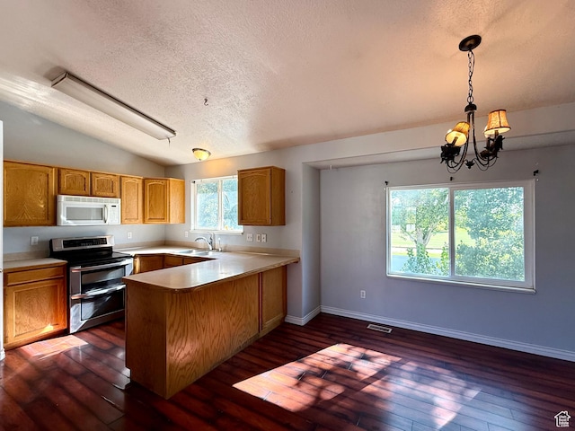 2573 W Remuda Dr, Farr West, UT 84404 - kitchen with white microwave, range with two ovens, a textured ceiling, a peninsula, and a chandelier