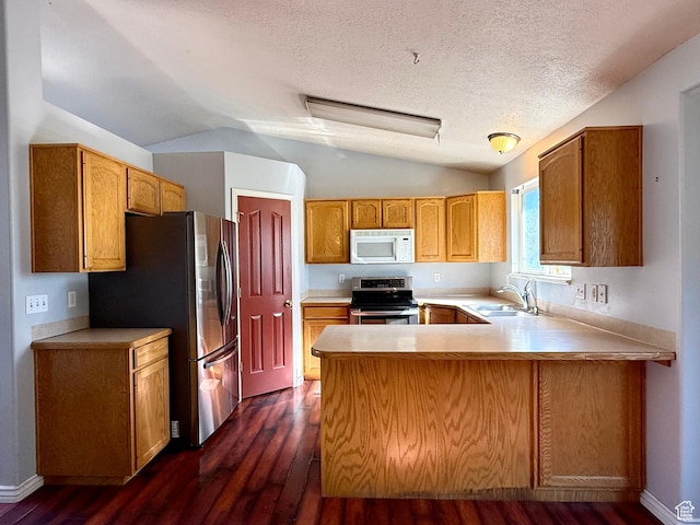 2573 W Remuda Dr, Farr West, UT 84404 - kitchen featuring appliances with stainless steel finishes, a peninsula, dark wood finished floors, light countertops, and lofted ceiling