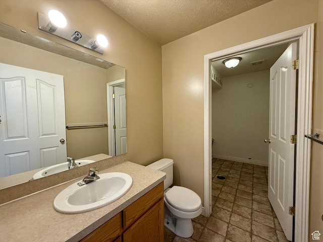 2573 W Remuda Dr, Farr West, UT 84404 - bathroom featuring vanity, a textured ceiling, and stone finish floors