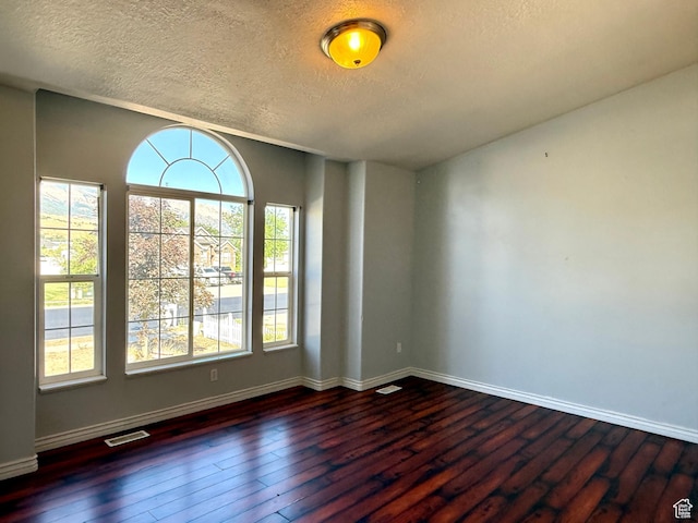 2573 W Remuda Dr, Farr West, UT 84404 - empty room with a textured ceiling and dark wood-style flooring