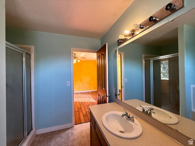 2573 W Remuda Dr, Farr West, UT 84404 - full bath featuring a shower stall, vanity, tile patterned flooring, and a textured ceiling