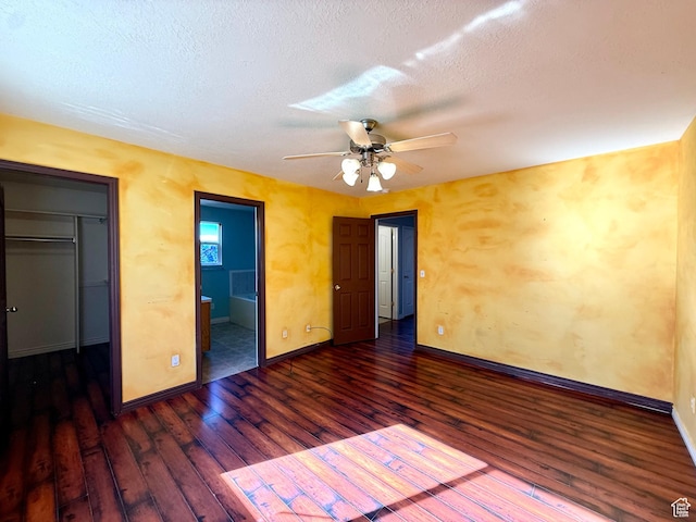 2573 W Remuda Dr, Farr West, UT 84404 - unfurnished bedroom featuring hardwood / wood-style floors, a spacious closet, connected bathroom, a textured ceiling, and ceiling fan
