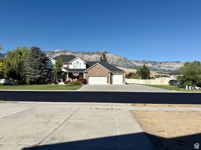 2573 W Remuda Dr, Farr West, UT 84404 - view of concrete driveway featuring a mountain view