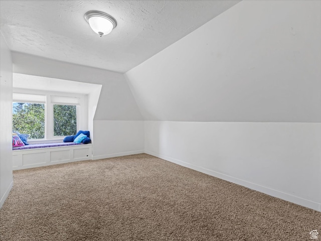 963 E 23rd St, Ogden, UT 84401 - bonus room featuring carpet flooring, vaulted ceiling, and a textured ceiling
