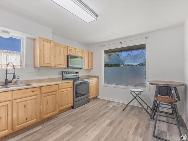 963 E 23rd St, Ogden, UT 84401 - kitchen with appliances with stainless steel finishes, light brown cabinets, light wood finished floors, and light countertops