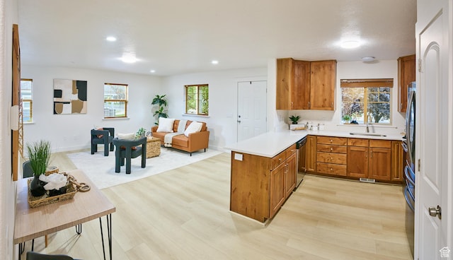 257 N 900 W, Provo, UT 84601 - kitchen with light wood-style flooring, brown cabinetry, dishwashing machine, a peninsula, and open floor plan