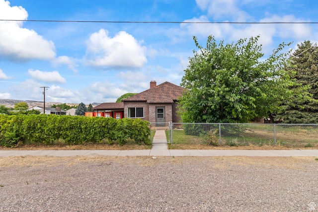 407 E 200 N, Richfield, UT 84701 - view of front of property featuring a fenced front yard, brick siding, and a chimney