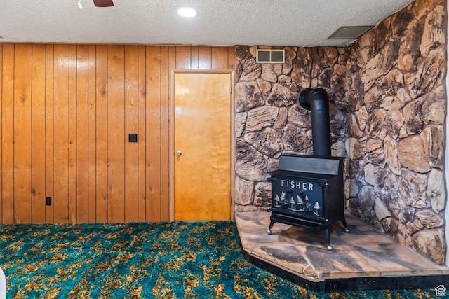 407 E 200 N, Richfield, UT 84701 - detailed view of a textured ceiling, wood walls, a wood stove, and carpet