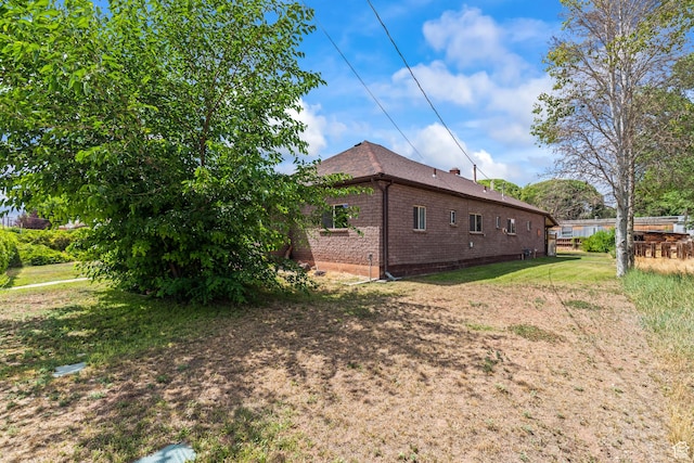 407 E 200 N, Richfield, UT 84701 - view of side of home featuring brick siding and a lawn