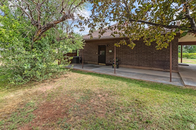 407 E 200 N, Richfield, UT 84701 - rear view of property with a yard, a patio area, and brick siding