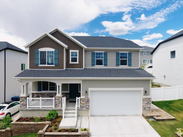 2123 N Wallflower Dr, Saratoga Springs, UT 84045 - craftsman-style house with covered porch, an attached garage, stone siding, driveway, and board and batten siding