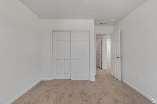 2123 N Wallflower Dr, Saratoga Springs, UT 84045 - unfurnished bedroom featuring light carpet, a closet, and a textured ceiling