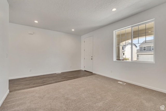 2123 N Wallflower Dr, Saratoga Springs, UT 84045 - spare room featuring dark carpet, recessed lighting, and a textured ceiling