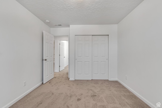 2123 N Wallflower Dr, Saratoga Springs, UT 84045 - unfurnished bedroom featuring carpet flooring, a textured ceiling, and a closet
