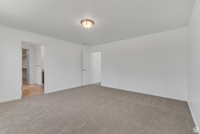 2123 N Wallflower Dr, Saratoga Springs, UT 84045 - carpeted empty room with baseboards and a textured ceiling