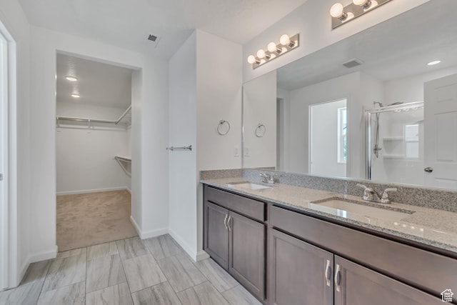 2123 N Wallflower Dr, Saratoga Springs, UT 84045 - bathroom featuring double vanity, a spacious closet, and a shower with shower door