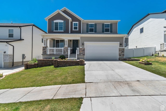 2123 N Wallflower Dr, Saratoga Springs, UT 84045 - view of front of house with a porch, an attached garage, stone siding, and concrete driveway